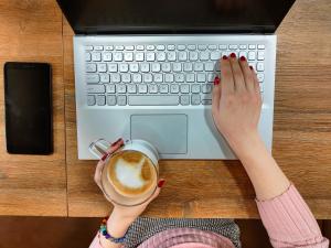 Woman on keyboard with coffee